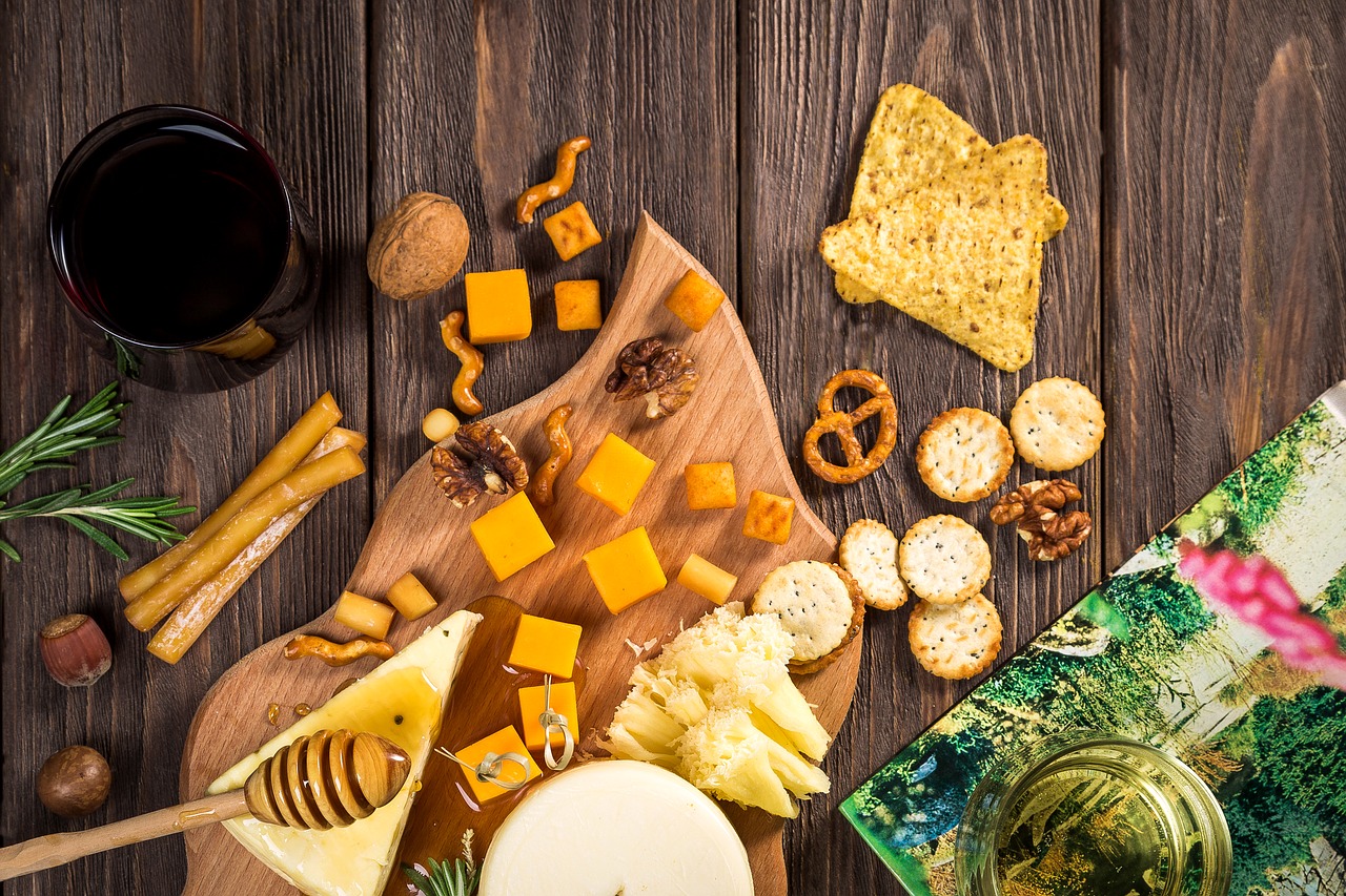 wine and cheese with nuts, pretzels and honey